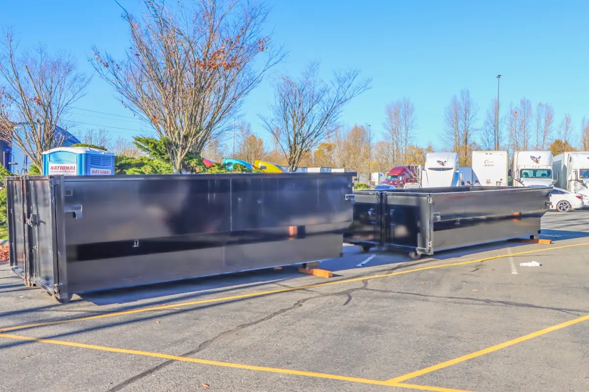 Professional dumpster rental service with roll-off container on residential driveway in Upton